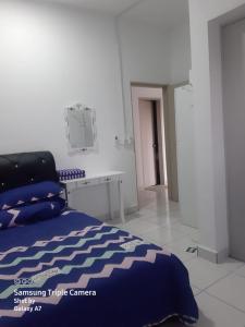 a bedroom with a bed and a desk at MEDINA's 5STAR CondoSTAY in Nilai in Nilai