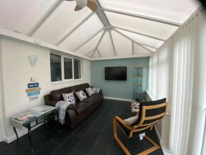 a living room with a couch and a tv at Craster Crew House in Craster