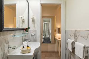 a bathroom with a white sink and a mirror at Hotel Accademia in Florence +61 photos