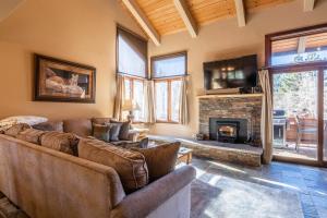 a living room with a couch and a fireplace at Sunrise 9 in Mammoth Lakes