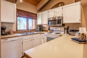 a kitchen with white cabinets and a counter top at Sunrise 9 in Mammoth Lakes