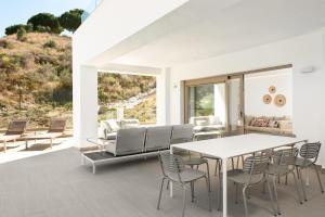 a dining room with a table and chairs at La Cala Golf Resort 3 Bed Apt - sleek corner plot in La Cala de Mijas