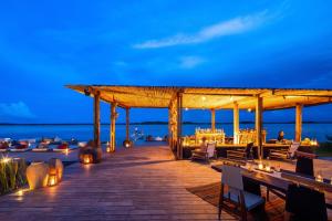 a restaurant on the beach at night at Our Habitas Bacalar in Bacalar