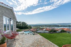 un patio avec deux chaises et une piscine dans l'établissement Casa Monte do Cervo, à Vila Nova de Cerveira