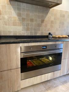a kitchen with an oven with some food in it at Holiday home Gite Saint Donat in Rendeux