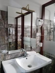 a bathroom with a sink and a mirror at Hotel Green View Buttala in Buttala