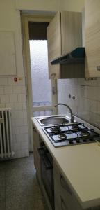 uma cozinha com um fogão e uma bancada em Casa arcobaleno em Asti
