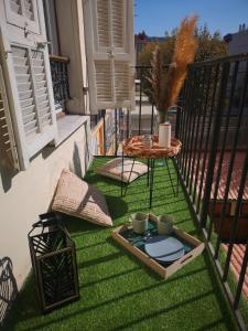 a small balcony with a table on the grass at A & K luxury appartments Port de Nice Garibaldi in Nice