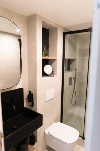 a bathroom with a shower and a toilet and a sink at A & K luxury appartments Port de Nice Garibaldi in Nice
