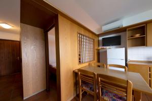 a kitchen with a table and chairs and a refrigerator at Residence Castelli in Brenzone sul Garda