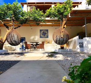 a patio with two baskets hanging from a house at Punta Sallustro Lipari in Lipari