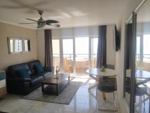 a living room with a couch and a table at Studio Apartment Ocean View in Portimão