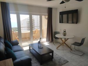 a living room with a couch and a table at Studio Apartment Ocean View in Portimão