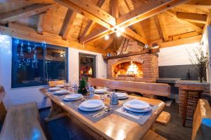 a dining room with a table and a fireplace at House Malkoc in Saborsko