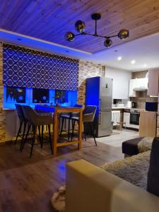 a kitchen and living room with a table and chairs at Hannah in Krāslava