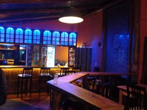 a bar with a wooden table and chairs at Sweet Guest House in Puerto Iguazú
