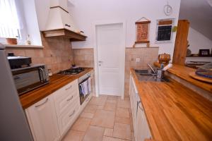 a kitchen with a sink and a stove top oven at Holiday Home Fiola in Zubovići