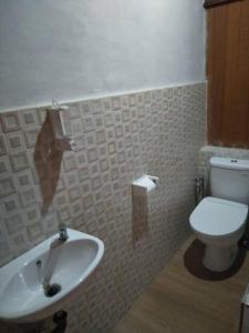 帕盧的住宿－Comfortable Great and Cheap，浴室配有白色卫生间和盥洗盆。
