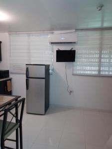 a kitchen with a black refrigerator in a room at Confort y Relajacion apto 5 in Dorado