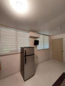 a kitchen with a stainless steel refrigerator in a room at Confort y Relajacion apto 5 in Dorado