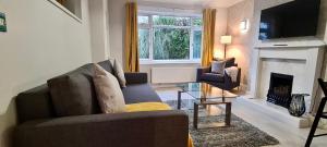 a living room with a couch and a fireplace at ✪ Spacious Luxury 2-bed w/ parking & garden in Killingbeck