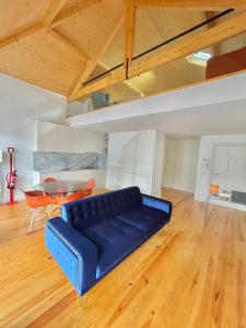 a blue couch in a living room with a table at Porto Domus 210 Penthouse in Porto