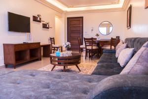 a living room with a couch and a table at Al Corniche Residence Sea View in Alexandria