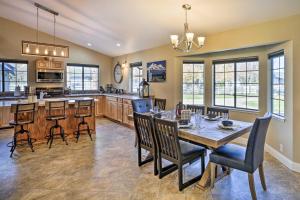 a dining room and kitchen with a table and chairs at Updated Cottonwood Home with Patio and Fire Pit! in Cottonwood