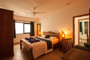 a hotel room with two beds and a window at Villa Face Mer in Anse Volbert Village