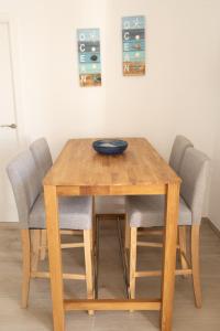 a wooden table with four chairs and a bowl on it at BALCO AL MAR in Peñíscola +14 photos