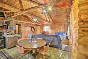 a living room and kitchen with a table and a couch at Cornell Home with Fire Pit and Hunting Access! in Cornell