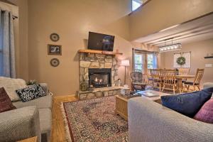 a living room with a fireplace and a dining room at Spacious Home in Helen with Porch and Balcony! in Helen