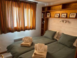 a bedroom with two twin beds with towels on them at Le CAPRICORNE OLYMPIE 3 in Les Allues +19 photos