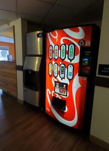 a soda machine with cell phones on the side of it at Westlake Inn in Strathmore