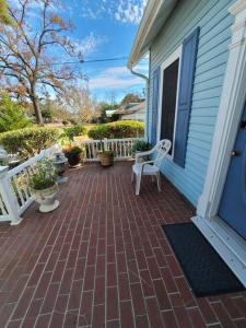 a patio with two chairs on a house at Cozy, Cute, Private Ozark Suite 5 Mins to Hospital in Ozark