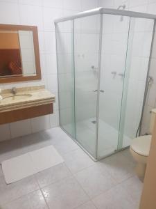 a bathroom with a shower and a sink and a toilet at Collina Hotel in Camapuã