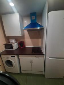 a small kitchen with a refrigerator and a microwave at Apartamento estacion de esqui la pinilla in La Pinilla