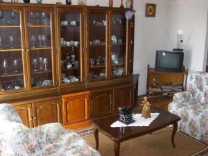a living room with a china cabinet and a tv at Mara in Barban