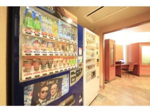 a soda machine in a store with advertisements on the wall at R&B HOTEL MORIOKA EKIMAE - Vacation STAY 38792v in Morioka