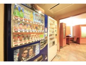 a soda machine in a store with advertisements on the wall at R&B HOTEL MORIOKA EKIMAE - Vacation STAY 38796v in Morioka