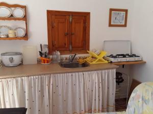 a kitchen counter with a sink and a stove at 2-Bed Apartment - Sleeps 3 - Parking - near Albox in Albox +6 photos