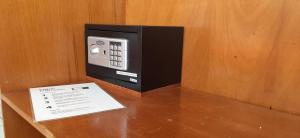 a pay phone sitting on top of a table at Pousada Milani in Florianópolis