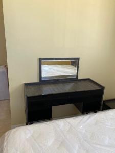 a dresser with a mirror on top of a bed at Lovely 3-Bed Apartment in Mogadishu in Mogadishu