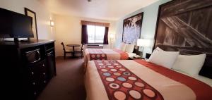 a hotel room with two beds and a flat screen tv at Westlake Inn in Strathmore
