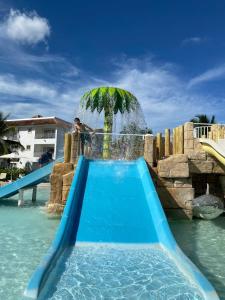 a water slide at a resort with a fountain at Cadaques Caribe Bayahibe in Bayahibe