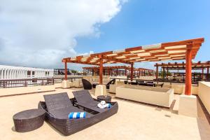 una terraza en la azotea con sillas negras y un pabellón en Aldea Thai by Stella Rentals, en Playa del Carmen