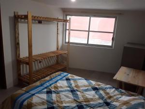 een slaapkamer met een bed en een raam bij Posada Loreto Xalapa in Xalapa