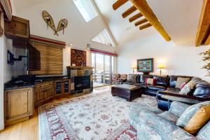 a living room with a couch and a fireplace at Saddle Ridge Townhome I-5 in Big Sky