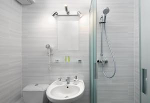 a white bathroom with a sink and a shower at U Komárků in Špindlerův Mlýn