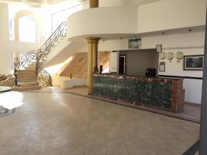 a large room with a staircase and a lobby at Holy Valley Hotel in Saint Catherine